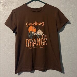 Something in the orange shirt